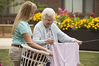 Senior Living Aide helping resident