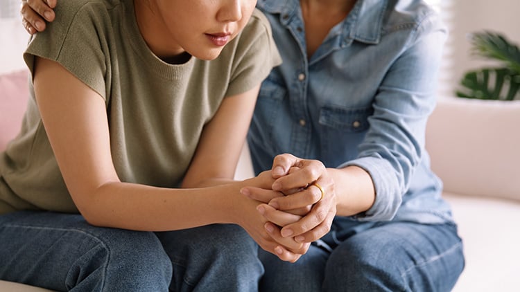 Older woman comforting a younger woman