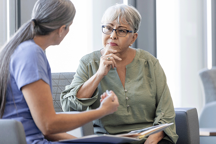 Nurse and middle age woman having Caregiving partnership conversation