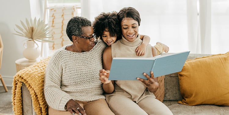 Grandmother, granddaughter and daughter reviewing scrapbook, Creating a Legacy in Retirement