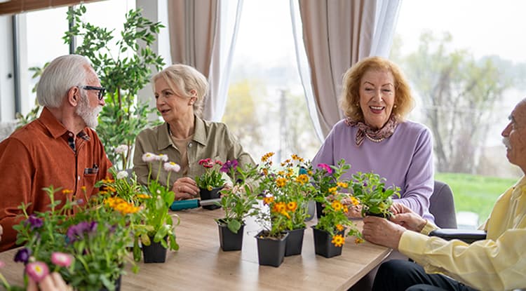 3 seniors at a garden class at a senior living community