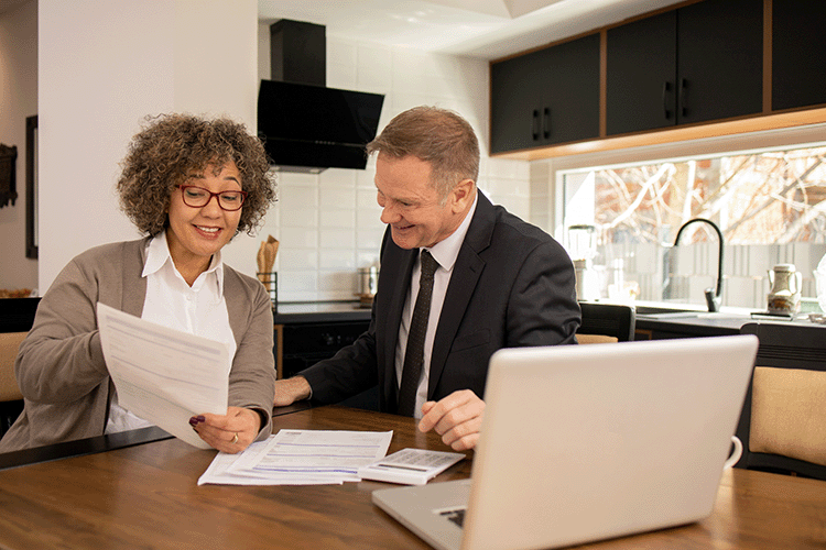 Man and Woman discussing tax gifting with a computer open