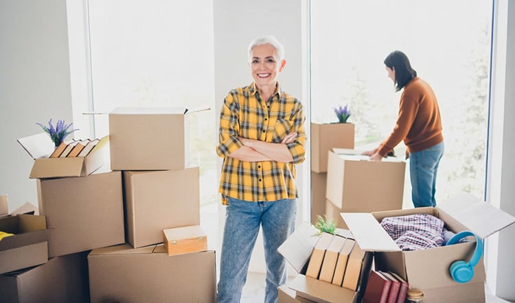 Senior woman surrounded by moving boxes