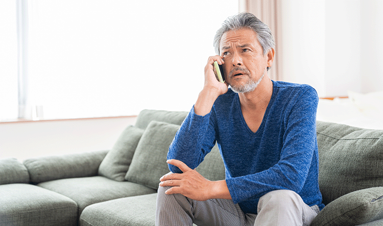 Older Male on phone worried about a senior scam
