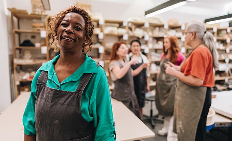 Older Woman with friends in ceramics studio