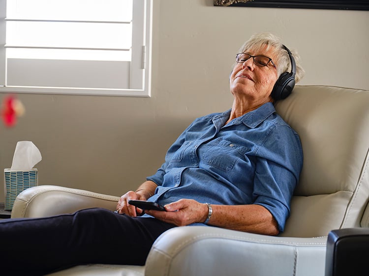 Senior Woman Relaxing in Recliner in new apartment
