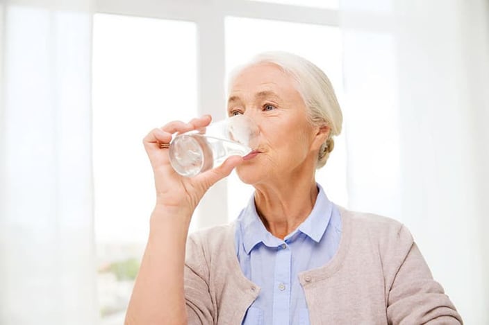Senior woman drinking water