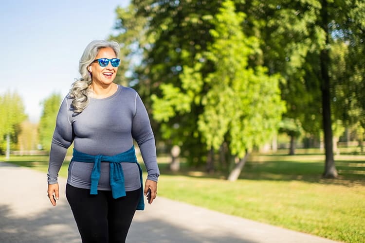 Senior woman talking a walk in a park