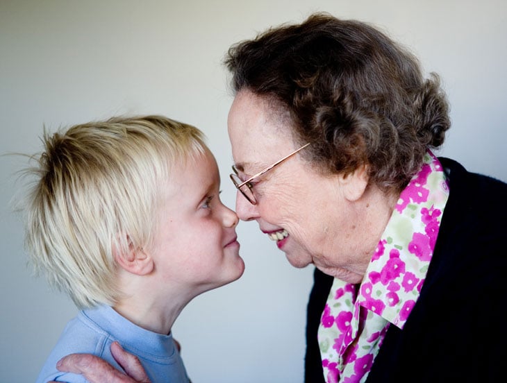 Senior-woman-touching-noses-child-boy