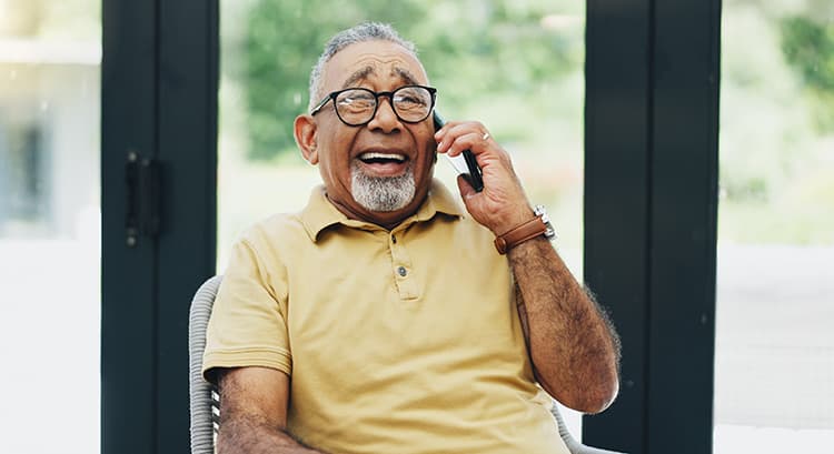 Smiling Senior Man with Dementia chatting on phone (1)