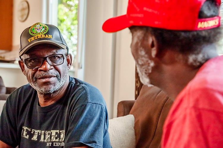 Older veterans talking with another veteran