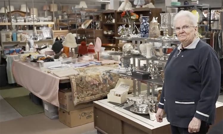 Senior Woman standing in thrift store, Volunteering in Retirement Sen