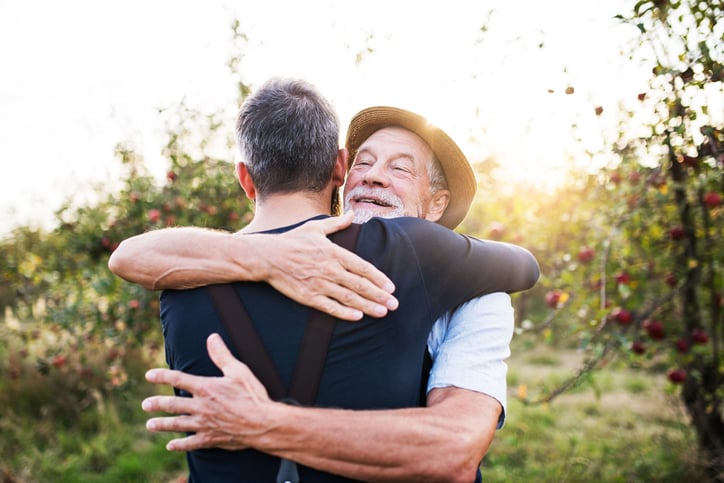 senior father son hugging