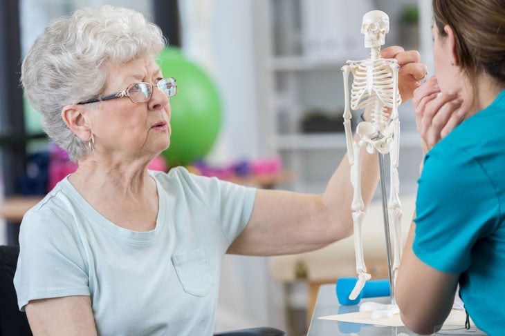 senior-woman-discussing-posture-with-physical-therapist