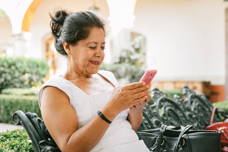 senior-woman-updating-social-media-technology-during-covid19