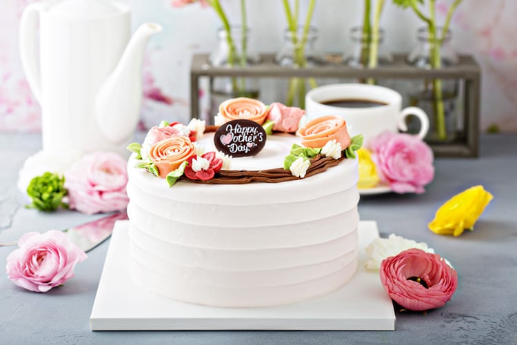 white cake decorated with flowers for mother's day