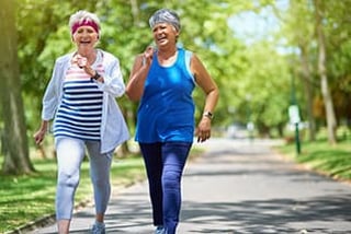 Two senior women walking exercise