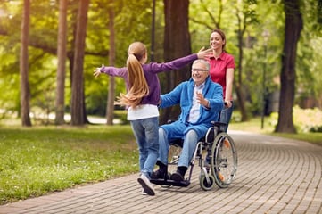 child running to man in wheelchair 