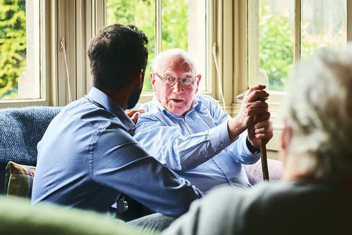 Son and elderly father having a conversation