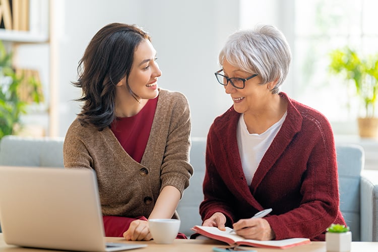 two seniors working at laptop